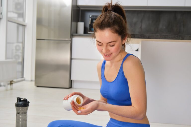 image-young-woman-sporty-fitness-girl-taking-vitamins-dietary-supplements-muscles-strength-scaled-1